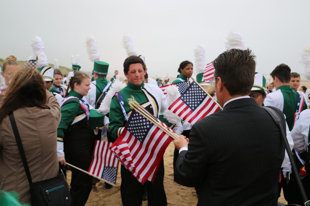 Band Director Shawn Smith hands out flags to the band members.